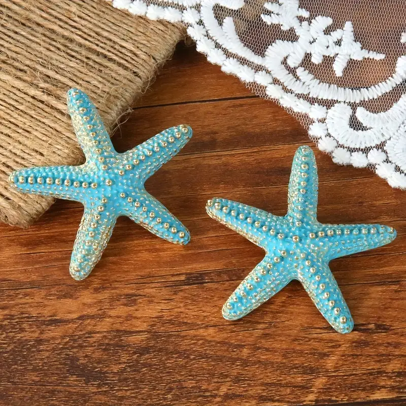 أقراط نجم البحر تركواز وذهبي، تصميم شاطئي أنيق للنساء مميز مستوحى من البحر يمنح إطلالة ناعمة وعصرية أقراط نجم البحر بلون تركواز وذهبي – تصميم شاطئي عصري بلمسة عتيقة